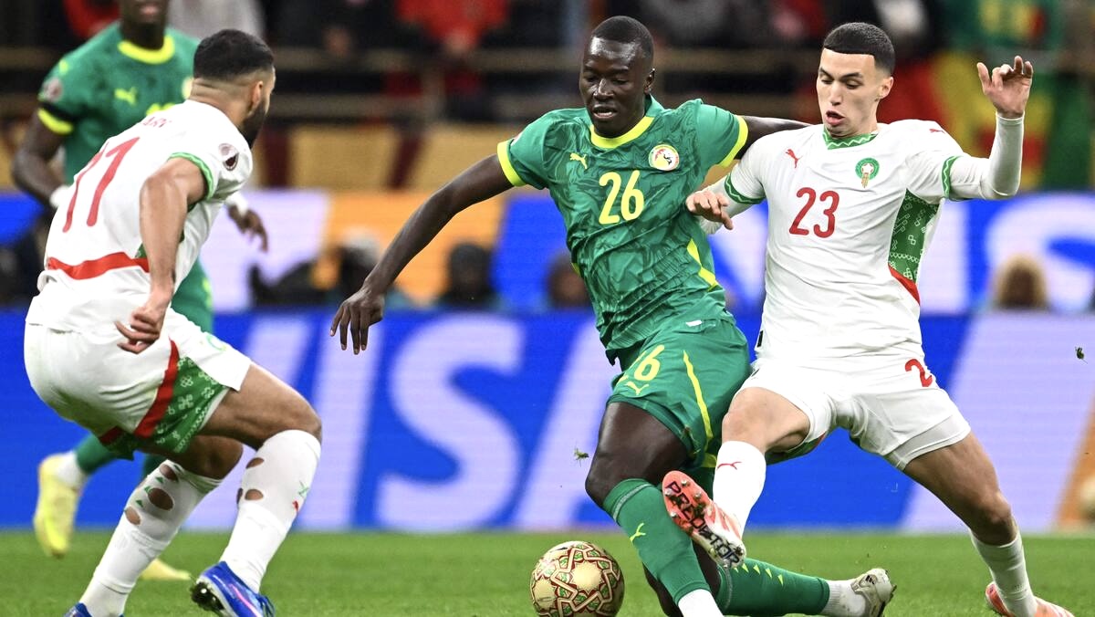 Pape Gueye conduit le ballon face aux défenseurs marocains